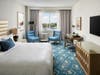 The hotel's color palette features hues of cream and blue. 