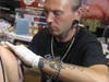 Chris Defiant is one of three artists at the studio. 