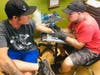 Artist Joe T. Izzo focuses on his latest artwork.