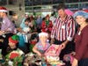 Kiwanians distribute Christmas gifts to needy children at Amalie Arena. 