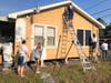 Kiwanians spruce up the home of a needy resident during Paint Your Heart Out.