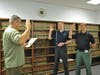 Officer Matthew Enhoffer, middle, is sworn in with Officer Brent McComas, left, after returning to the St. Petersburg Police Department in January 2015. 