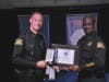 Officer Matthew Enhoffer received the Medal of Valor from Police Chief Anthony Holloway, left,  in October 2015. 