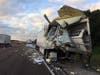A tractor-trailer truck transporting mail collided with another tractor-trailer truck, causing mail to be scattered across Interstate 75.