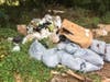 Among the debris were two boxes marked "corrosive," which contained nine 1-gallon containers of muriatic acid. 