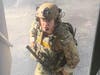 SWAT team member prepare to burst into the apartment if necessary. 