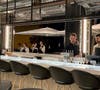 The mixologist bar is equipped with garage doors that open onto the patio.