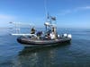 The team searches for the whale and prepares to launch a hexacopter to capture aerial images of the right whale mother and calf pair.