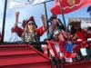 Riverview resident Lisa Esposito tosses beads to parade spectators from the Ye Notorious Krewe of the Peg Leg Pirates float.