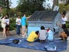 Residents transform a dumpster as part of the city's Dumpster Art Program. 