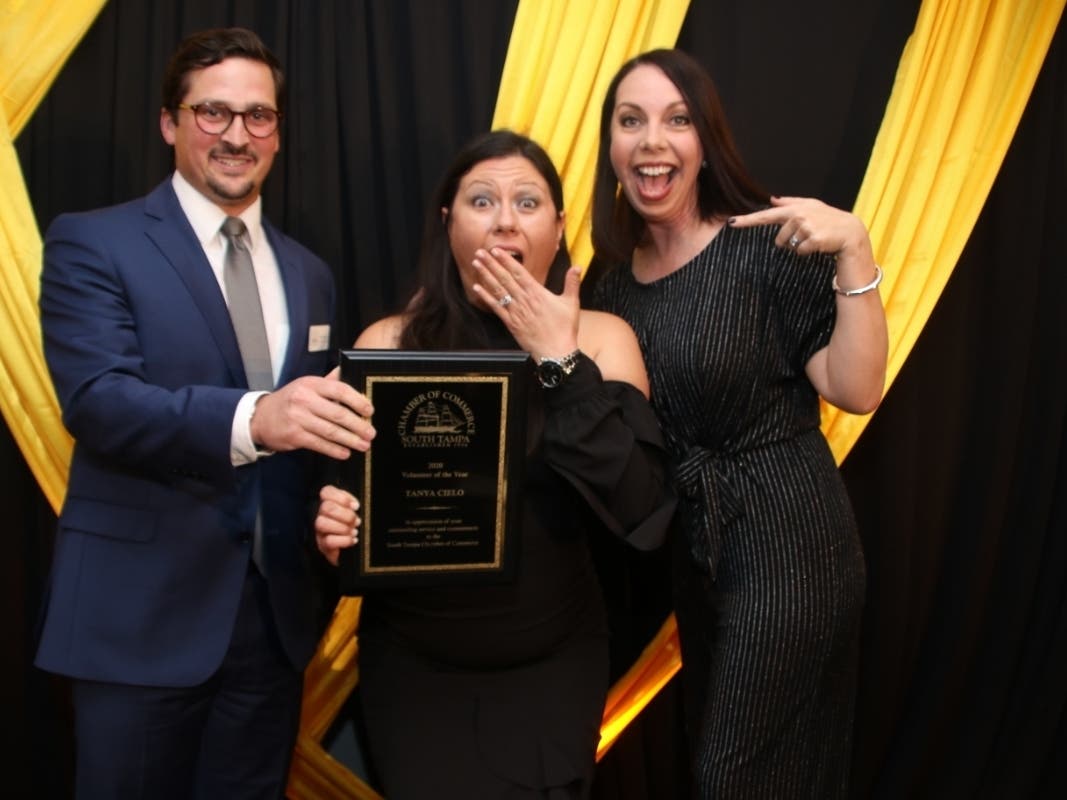 Tanya Cielo, center, accepts the 2020 Volunteer of the Year award from STCOC President and CEO Kelly Flannery and membership manager Beau Giles 