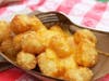 Sides include tator tots with cheese and crawfish etouffee fries.