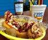 The Heisman ‘Dog features fried dat chick, honey mustard, barbecue sauce and grilled onions. It goes great with a boozy Peach Bowl Shake (vanilla ice cream, peach purée, and a big splash of Old Forester Kentucky Bourbon).