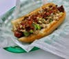 The Son of a Saint is loaded with duck sausage, grilled onions, jalapeños, celery, creole mustard, blackberry sauce and bacon​.