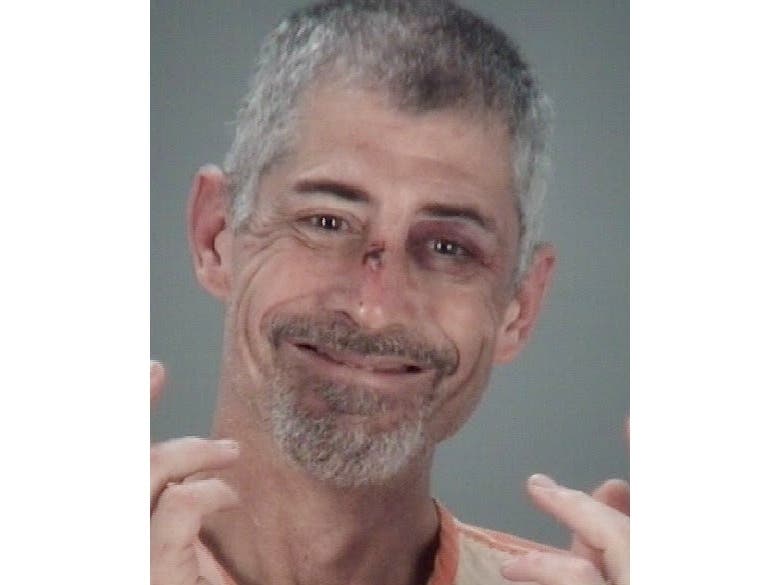 Mark Brienza is accused of kicking, biting and threatening deputies.