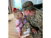 Sgt. Frederick Harmon kisses his 2-year-old daughter goodbye.