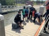 The Coast Guard and a good Samaritan rescued four boaters from an overturned 16-foot vessel in Tampa Bay Wednesday.