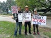 DIck Maxwell (center), 66, was among those who rallied Sunday in favor of reopening Florida.