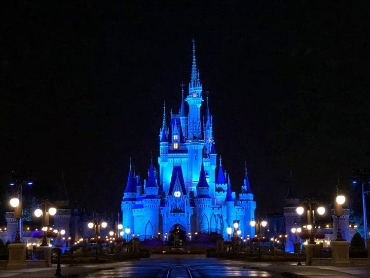 Cinderella Castle shines blue at Magic Kingdom Park in honor of front-line medical professionals.