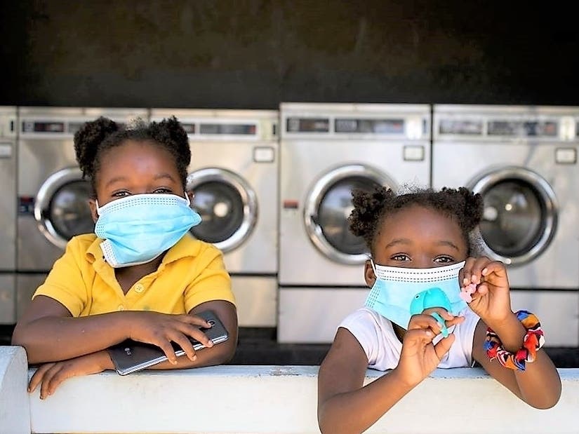 Two youngsters sport face masks at a Tampa laundromat. 