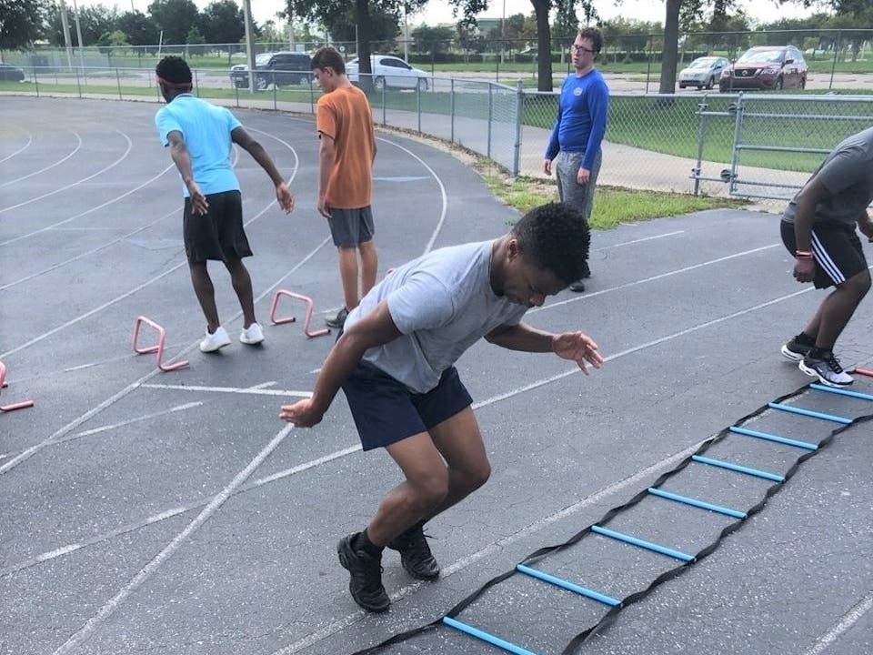 Football players run drills at Lennard High School.