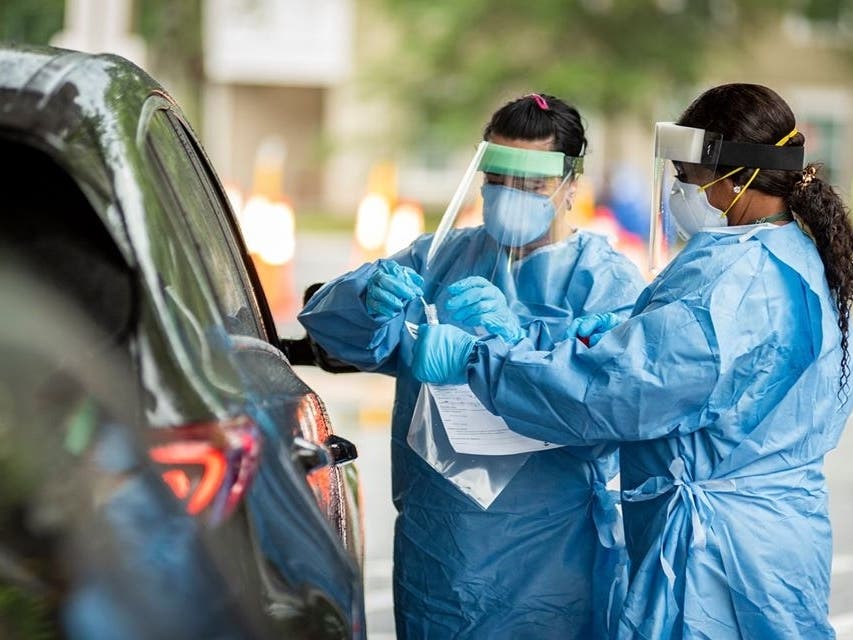 Health services students conduct drive-thru tests. 