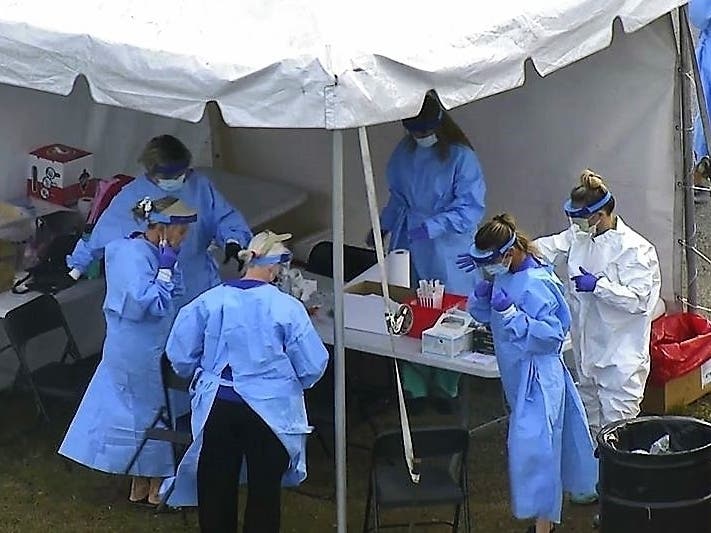Medical personnel provide tests at Raymond James Stadium.