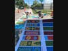 Artist Jay Giroux of the READ Movement painted the crosswalk mural featuring designs book titles selected by the school.