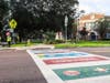 Artist Jay Giroux of the READ Movement painted the crosswalk mural featuring designs book titles selected by the school.