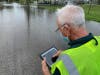 Kevin Hilpl from the Pinellas County Building Department evaluates a flooded area. 
