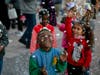Children enjoy a rare "snowfall" at Winter Village.
