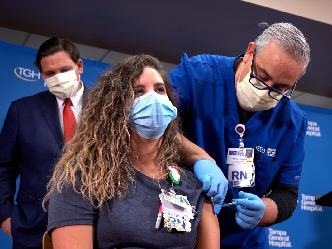 All eyes were on Tampa General Hospital coronavirus unit nurse Vanessa Arroyo, including Florida Gov. Ron DeSantis's, as she prepared to receive the first coronavirus vaccine Monday. 