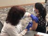 BayCare’s manager of employee health, Milissa Sulick, provides a COVID-19 vaccination to Deanna Myers, RN. Myers, who works in the Steinbrenner Emergency Center at St. Joseph’s Children’s Hospital, volunteered to receive the vaccine to protect herself,