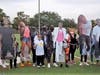 Family members pose with life-size cardboard cutouts of their loved ones lost to gun violence this year in Tampa. 
