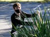 Brian Boehm, a junior cybersecurity major, weeds a median in one of Saint Leo University’s parking lots.