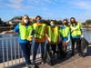 Members of the Super Bowl Green Team clean up trash on the Tampa Riverwalk.