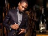 NFL legend Charles Woodson autographs a bottle of wine.