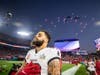 Wide receive Mike Evans salutes the flag as Strike Command bombers fly over Raymond James Stadium during the national anthem.