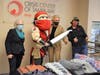 Hillsborough County Commissioner Pat Kemp, Tampa Mayor Jane Castor and Crisis Center of Tampa Bay President Clara Reynolds accepts donations delivered by NFL staff and Captain Fear.