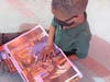 Some students were so excited, they plopped down on the sidewalk in front of the school's media center and began reading their new books.
