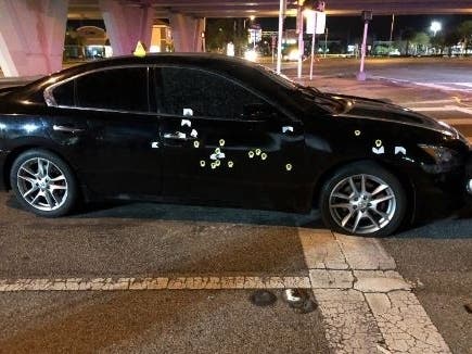 A car was struck by more than a dozen bullets, killing one of its occupants. 