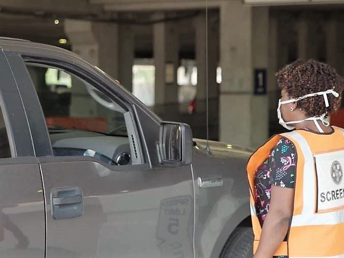 An employee directs a patient through the drive-thru vaccination site at James A. Haley Veterans' Hospital in Tampa. 