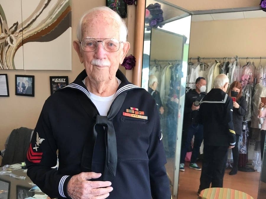 Joseph Hall, 97, shows off the exact copy of the Navy uniform made by Susan Williams.