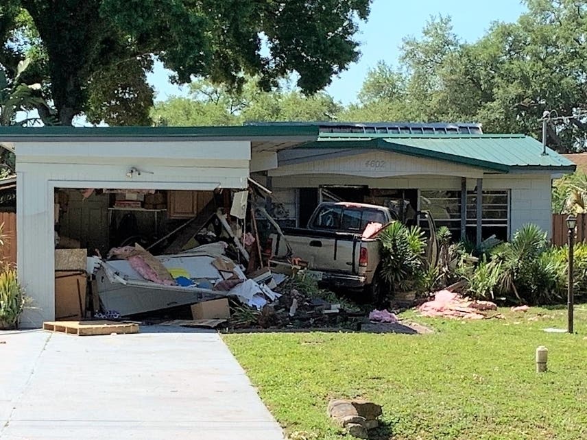 The Tampa police bomb squad and hazardous materials team were called in after a truck driver drove into a house Tuesday morning.