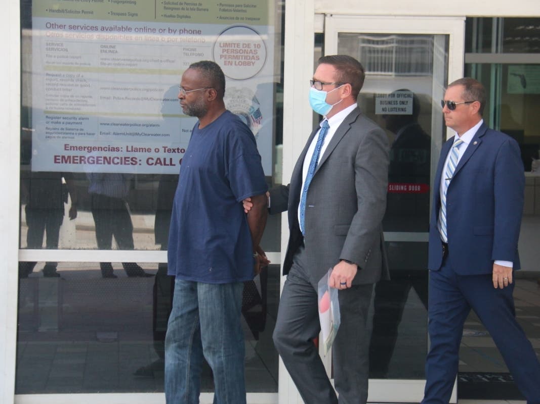 Clearwater homicide detectives escort Arthur Benjamin Jr. from the Clearwater Police Department headquarters. He is charged with murder in the May 1 slaying of a transgender woman.