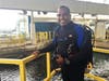 Edwin Rodriguez is often seen in a wetsuit cleaning the interiors of the marine exhibits. 
