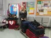 Elizabeth Urquiola poses with luggage donated by the Pasco County Tax Collector’s Office staff members.