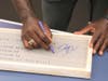 Titus O'Neil signs the plaque dedicating the new lab at Pasco Middle School.