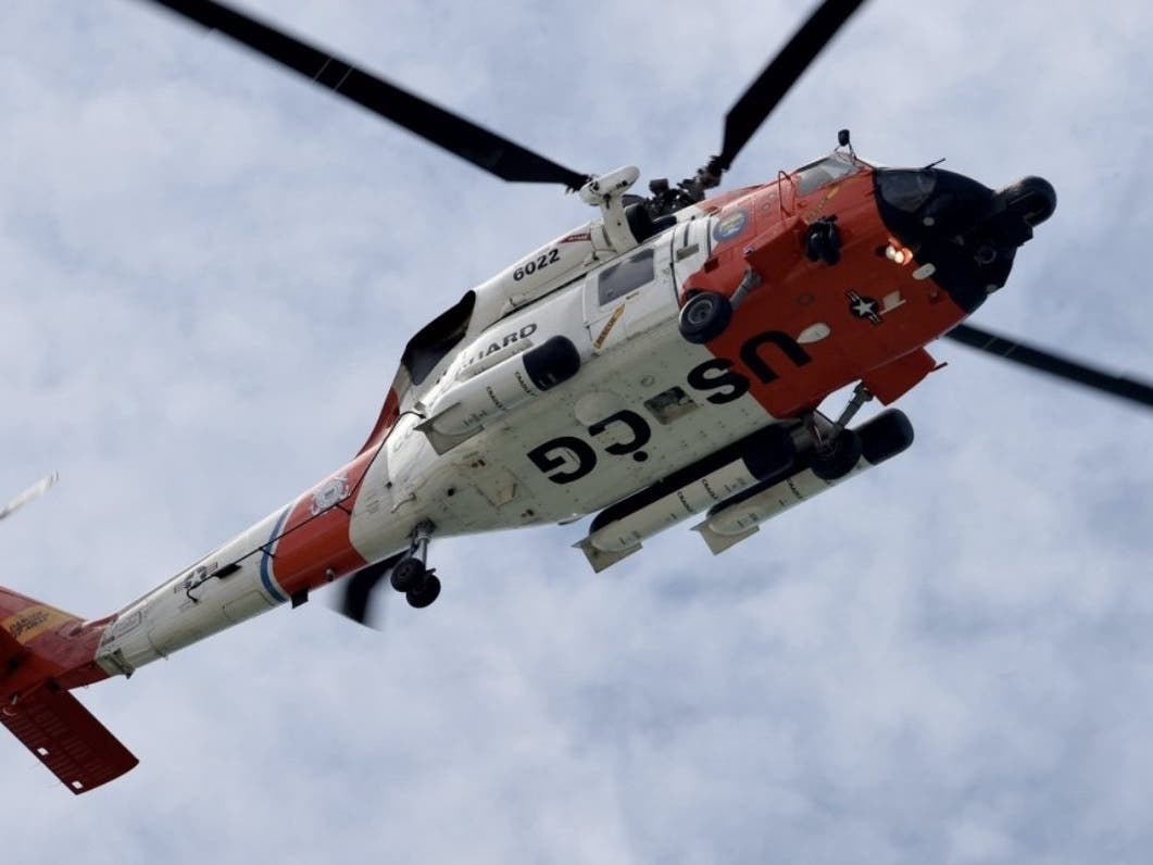 A Coast Guard Air Station Clearwater MH-60 Jayhawk helicopter crew arrived on the scene and safely hoisted Sarah Rice into the helicopter.