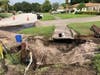 The vehicle came to stop on top of a fire hydrant, damaging the hydrant and causing a hole to form amid the water leak, sending a large amount of dirt into the roadway.